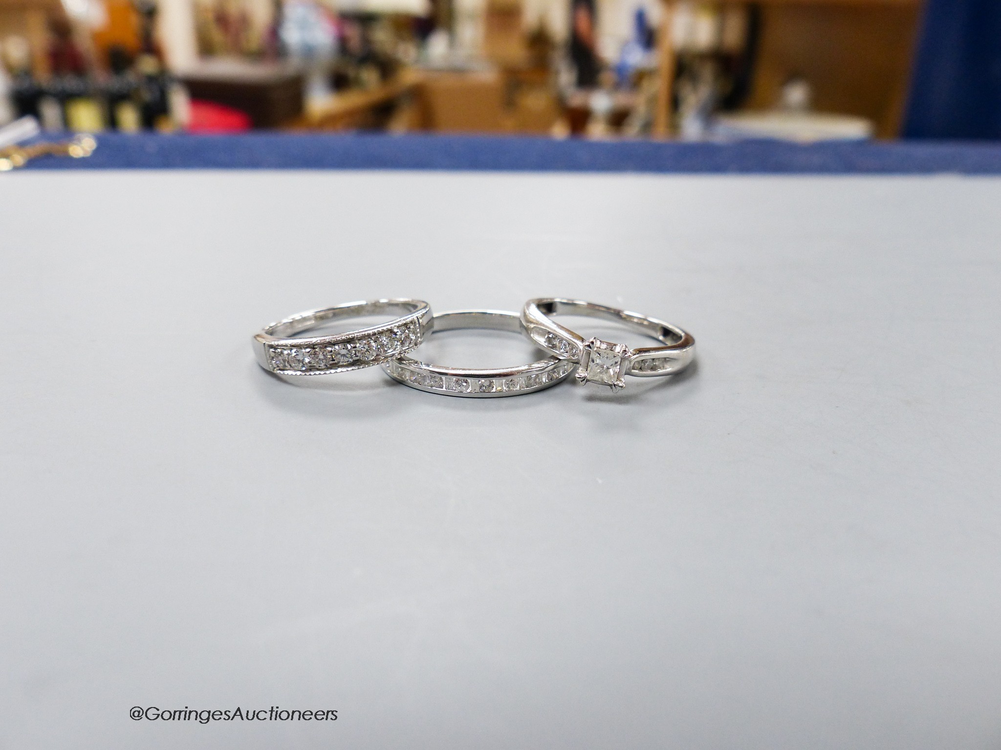 Two modern 9ct white gold and diamond set rings including a seven stone half hoop and a white metal and diamond chip set half eternity ring, gross 6.9 grams.